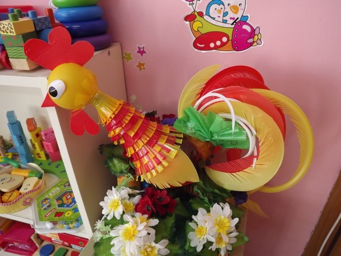Children's craft made of plastic bottles in the shape of a rooster