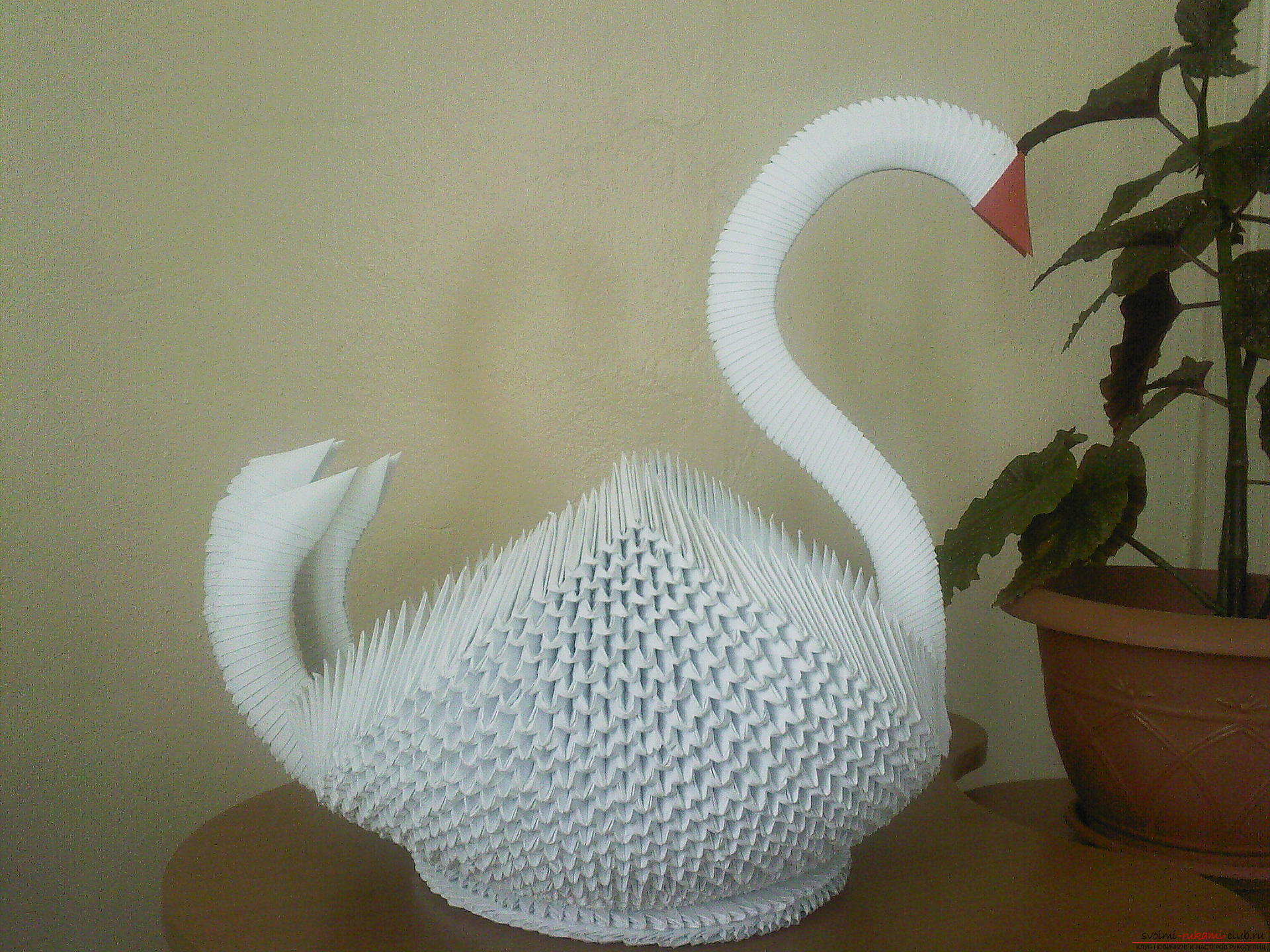 A simple figure of a swan in the technique of origami. Photo # 2