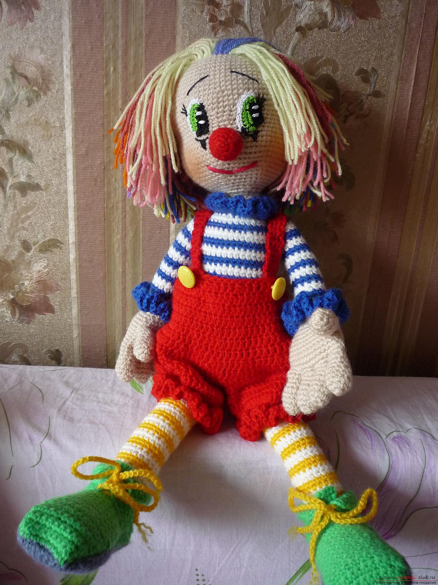 Detaljerede billeder af en clown legetøj hæklet af multi-farvet garn. Foto # 2