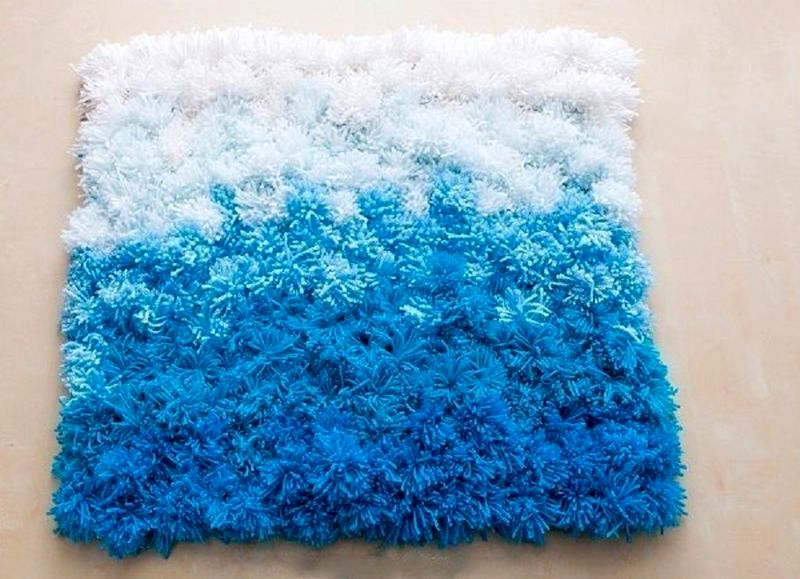 white and blue pompom rug