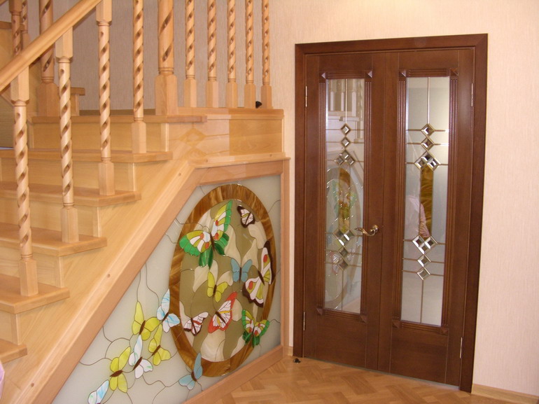 Stained-glass window on the door and the space under the stairs