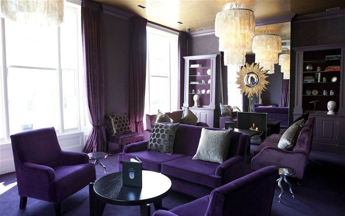 Purple sofa in a dark interior photo