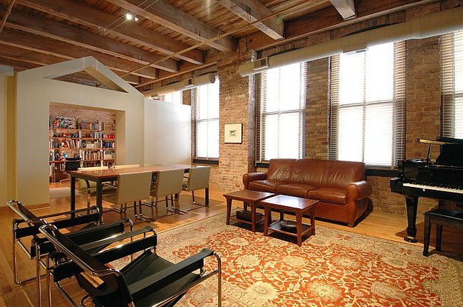 Loft style living room with open brick wall photo