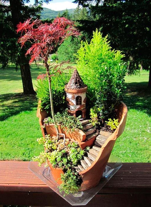 small garden in a broken ceramic pot