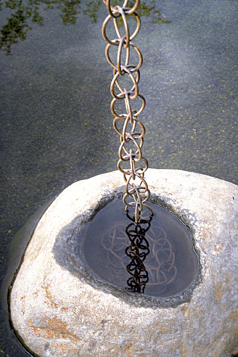 stone cup and copper chain for collecting rainwater