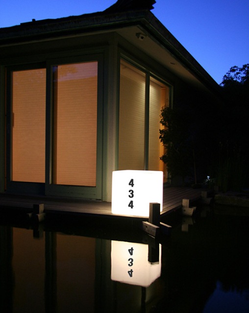 Glowing column with the number of the house