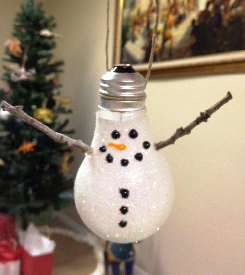 Christmas tree toy with a snowman with your hands from a light bulb