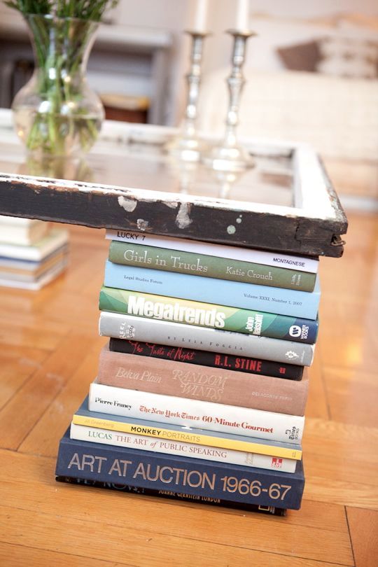 A coffee table from the window and books with their own hands