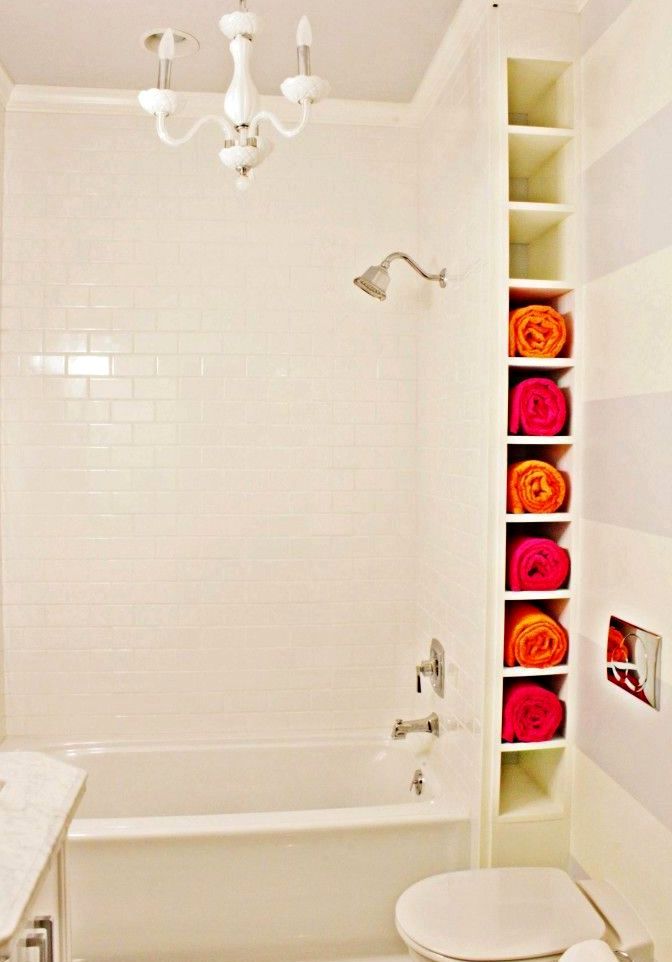 Narrow shelves for storing towels behind the bathroom wall