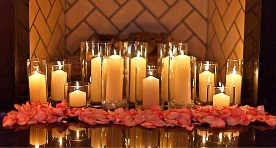 Decor for February 14: floor candles in glass candlesticks and rose petals
