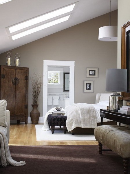 Bright attic bedroom with dark furniture