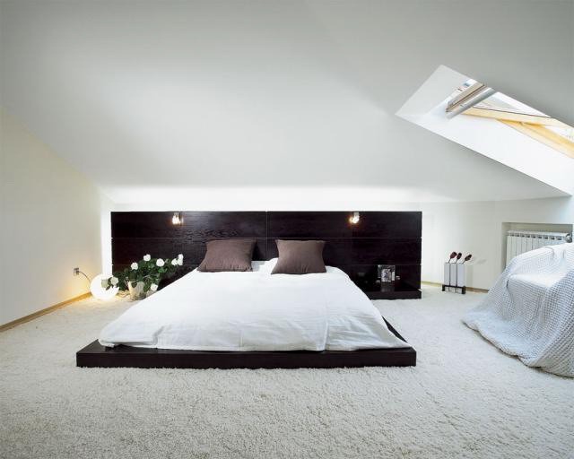 White bedroom with a bed on the floor