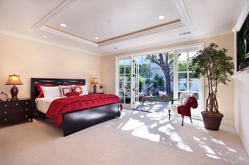 Black furniture in a spacious, bright bedroom