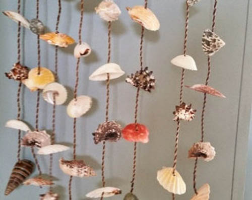 Pendants on the door with their own hands from seashells